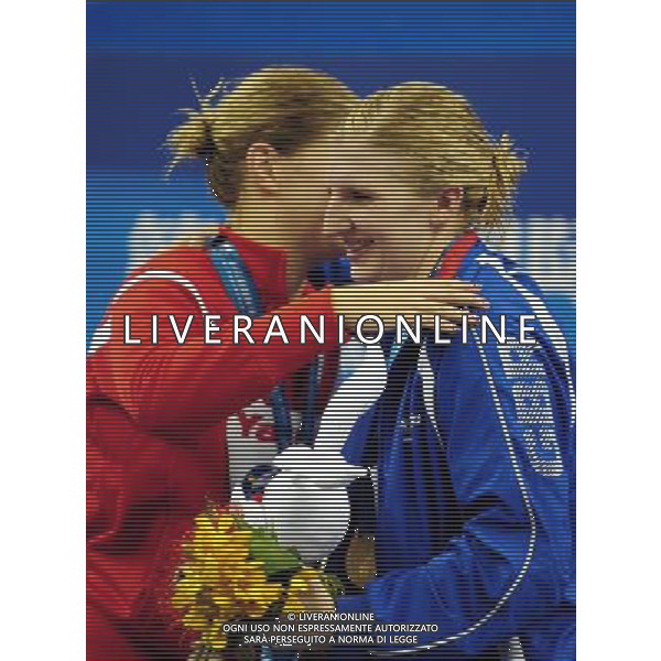 (110730) -- SHANGHAI, July 30, 2011 () -- Rebecca Adlington of Britain hugs Lotte Friis (L) of Denmark in the awarding ceremony of women\'s 800m freestyle swimming event at the 14th FINA World Championships in Shanghai, east China, July 30, 2011. Rebecca Adlington of Britain claimed the title with 8:17.51. Lotte Friis won the silver medal with 8:18.20. (/Yang Zongyou) (sqq)