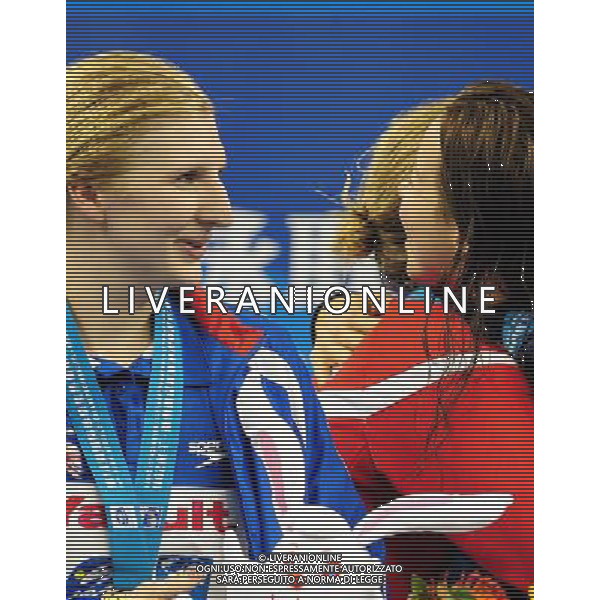 (110730) -- SHANGHAI, July 30, 2011 () -- Lotte Friis of Denmark (C) hugs with Kate Ziegler (R) of the United States as Rebecca Adlington (L) of Britain looks on during the awarding ceremony of women8ÿs 800m freestyle swimming event at the 14th FINA World Championships in Shanghai, east China, July 30, 2011. Rebecca Adlington of Britain claimed the title with 8:17.51. Lotte Friis won the silver medal with 8:18.20. Kate Ziegler got the bronze medal with 8:23.36. (/Yang Zongyou) (sqq)