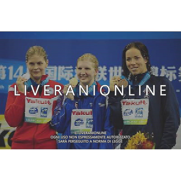 (110730) -- SHANGHAI, July 30, 2011 () -- Rebecca Adlington (C) of Britain, Lotte Friis (L) of Denmark, Kate Ziegler of the United States pose in the awarding ceremony of women8ÿs 800m freestyle swimming event at the 14th FINA World Championships in Shanghai, east China, July 30, 2011. Rebecca Adlington of Britain claimed the title with 8:17.51. Lotte Friis won the silver medal with 8:18.20. Kate Ziegler got the bronze medal with 8:23.36. (/Yang Zongyou) (sqq)