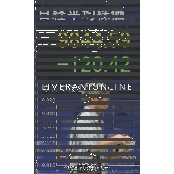(110802) -- TOKYO, Aug. 2, 2011 () -- A man walks past a screen displaying Japan\'s stock price index in Tokyo, capital of Japan, Aug.2, 2011. Japan\'s stocks fell across the board Tuesday, as concerns on the U.S. economy was rekindled and a strong yen continue to squeeze export-oriented shares. (/Kenichiro Seki) (zf)