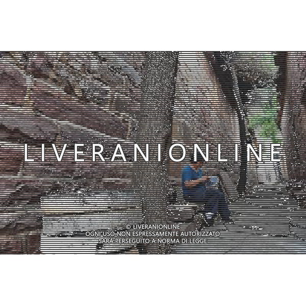 (110802) -- SHIJIAZHUANG, August 2, 2011 () -- A woman does needlework on the alley of Wangnao Village in Shahe City, north China\'s Hebei Province, July 26, 2011. Wangnao Village is said to form during the 1403-1425 period. The flavor of the village is remained even after hundreds of years -- it has more than 72,000 square meters of stone-built houses, accounting for two-thirds of its total area, and above 310 families live in more than 100 houses here. (/Yang Shiyao) (zl) (lfj)