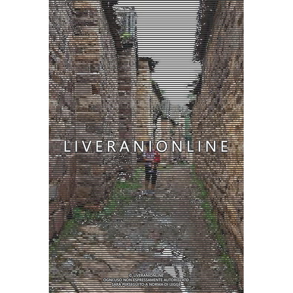 (110802) -- SHIJIAZHUANG, August 2, 2011 () -- A woman, embracing a child, walks on the alley of Wangnao Village in Shahe City, north China\'s Hebei Province, July 26, 2011. Wangnao Village is said to form during the 1403-1425 period. The flavor of the village is remained even after hundreds of years -- it has more than 72,000 square meters of stone-built houses, accounting for two-thirds of its total area, and above 310 families live in more than 100 houses here. (/Yang Shiyao) (zl) (lfj)