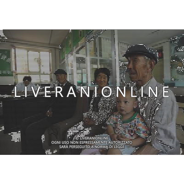 (110802) -- LANZHOU, Aug. 2, 2011 () -- Villagers wait to see the doctor in a clinic of Ma\'er Village, Liangzhou District, Wuwei City, northwest China\'s Gansu Province, July 29, 2011. On July 29 in a village clinic, Chang Faguo, 70, of the Luzhou village, receives herbal drugs from doctor Zhang Yuwen of Ma\'er Village neighbouring Luzhou and then rides home. Luzhou, located in the Wuwei City\'s Liangzhou District in northwest China\'s Gansu Province, is one of the impoverished villages in the poor province. Herbal drugs are very common in Liangzhou where most of the village doctors are skillful at the Traditional Chinese Medicine (TCM). \'Compared with Western medicines, herbal drugs are really cheap for farmers, especially in treating chronic diseases,\' Zhang said, \'take Chang for example, he needs a long-term medication as he has suffered from chronic stomach disease for nearly 20 years. Conventional chemical drugs will cost him 24 RMB yuan every two days whereas the TCM herbs only need 14 RMB yuan. Saving 10 RMB yuan matters much for a famer\'s family whose annual income is merely 5,000 RMB yuan.\' After the founding of the People\'s Republic of China in 1949, rural people had access to subsidized health clinics run by \'barefoot doctors,\' who were basically middle-school students trained in first aid. Those \'barefoot doctors\' used to prescribe herbs to treat diseases for farmers, which were common and easy to obtain in the countryside. The primitive service, essentially free, played a role in doubling the country\'s average life expectancy from 35 years in 1949 to 68 years in 1978. When China began its economic reform in the early 1980s, the system was dismantled as the country attempted to switch to a market-oriented healthcare system. But the government failed to establish a viable substitute, leaving its large rural population without health insurance. A national health survey in 2003 revealed about 73 percent of people in rural areas who should have soug