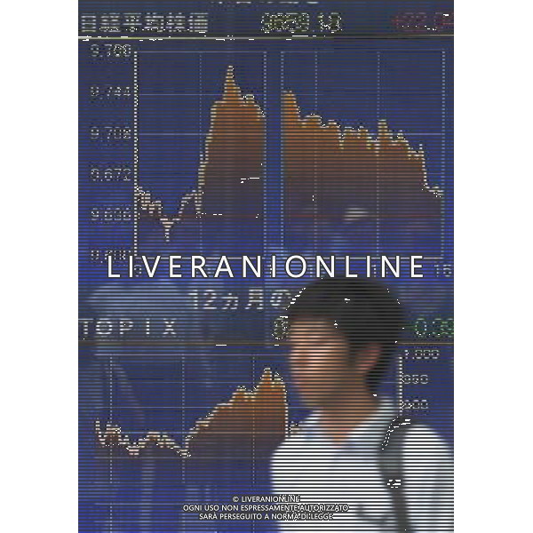 (110804) -- TOKYO, Aug. 4, 2011 () -- A man walks past a stock share price board in Tokyo, capital of Japan, Aug. 4, 2011. Tokyo share prices closed 0.23 percent higher Thursday. (/Kenichiro Seki) (lt)