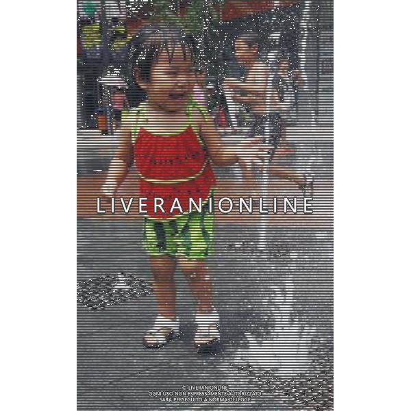 (110805) SHENYANG, Aug. 5, 2011 A little girl cools off at a fountain in Shenyang, capital of northeast China\'s Liaoning Province, Aug. 5, 2011. The city is experiencing a hot summer, with the highest temperature reaching 31 degrees Centigrade on Friday. (/Yang Qing) (ry)