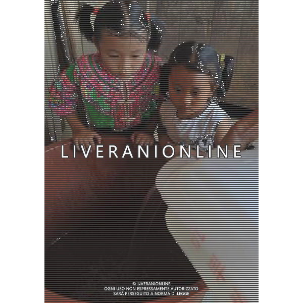 (110804) -- LONGLIN, Aug. 4, 2011 () -- Children watch water being poured into a water vat in Longlin, south China\'s Guangxi Zhuang Autonomous Region, Aug. 4, 2011. A continuous drought has dried up rivers and reservoirs in the county of Longlin, with water reserves decreasing by 65 percent from previous years, forcing villagers to tramp over mountains to carry water for daily use.(/Zhou Hua) (gsy) (ljh)