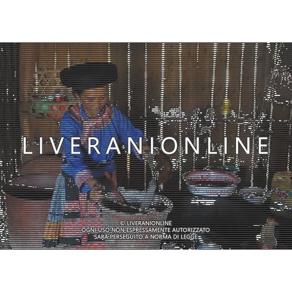 (110804) -- LONGLIN, Aug. 4, 2011 () -- A villager pours water for reusing in Longlin, south China\'s Guangxi Zhuang Autonomous Region, Aug. 4, 2011. A continuous drought has dried up rivers and reservoirs in the county of Longlin, with water reserves decreasing by 65 percent from previous years, forcing villagers to tramp over mountains to carry water for daily use.(/Zhou Hua) (gsy) (ljh)