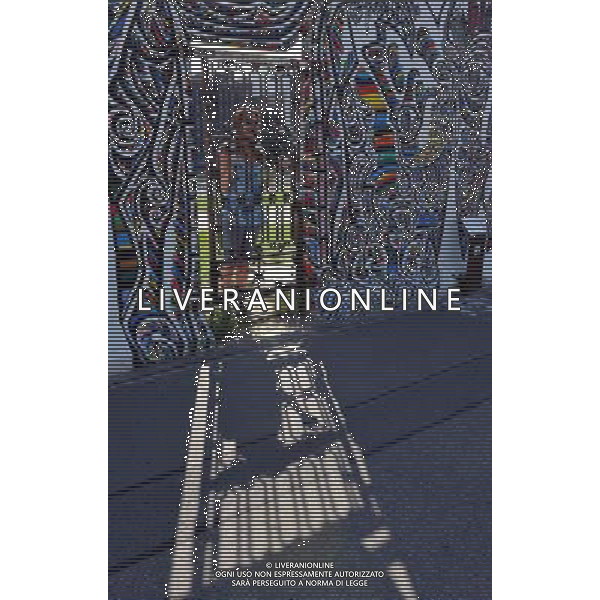 (110810) -- BERLIN, August 10, 2011 () -- Tourist stands for picture at East Side Gallery, the largest remaining part of the former Berlin Wall in Berlin, capital of Germany on August 6, 2011. Berlin is marking the 50th anniversary of the Berlin Wall, which started building on August 13, 1961. (/Ma Ning)