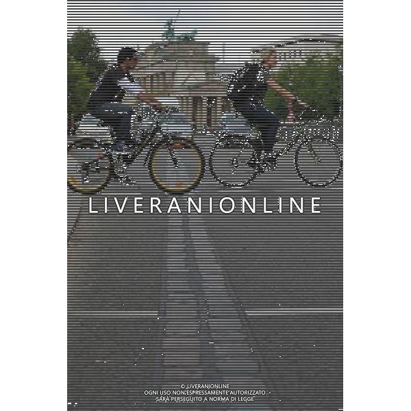 (110810) -- BERLIN, August 10, 2011 () -- Cyclists pass the track line of the former Berlin Wall near Brandenburger Gate, central of Berlin, capital of Germany on August 1, 2011. Berlin is marking the 50th anniversary of the Berlin Wall, which started building on August 13, 1961. (/Ma Ning)