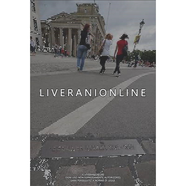 (110810) -- BERLIN, August 10, 2011 () -- Tourists walk pass a plaque noting the track of former Berlin Wall in front of Brandenburger Gate, central of Berlin, capital of Germany on August 1, 2011. Berlin is marking the 50th anniversary of the Berlin Wall, which started building on August 13, 1961. (/Ma Ning)