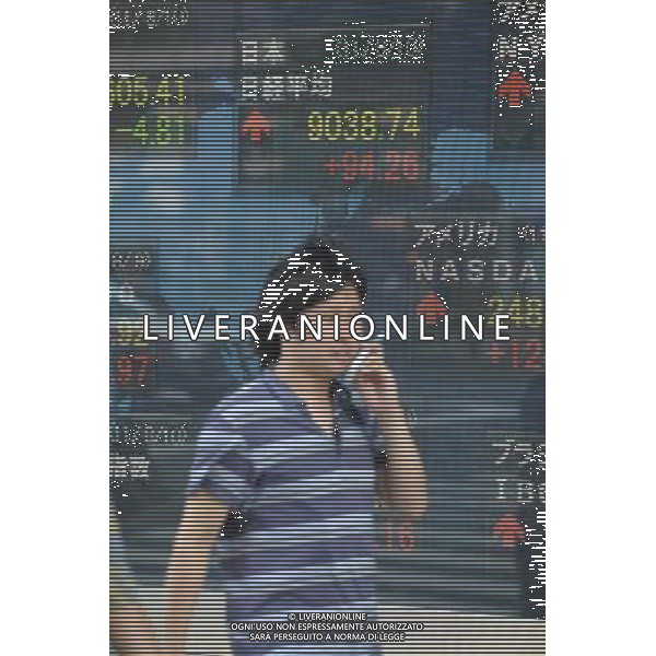 (110810) TOKYO, Aug.10, 2011 A man walks past a stock share price board in Tokyo, capital of Japan, Aug. 10, 2011. The benchmark 225 issue Nikkei Stock Average rose 94.26 points, or 1.05 percent, to close at 9,038.74 on Wednesday. (/Kenichiro Seki)(yt)