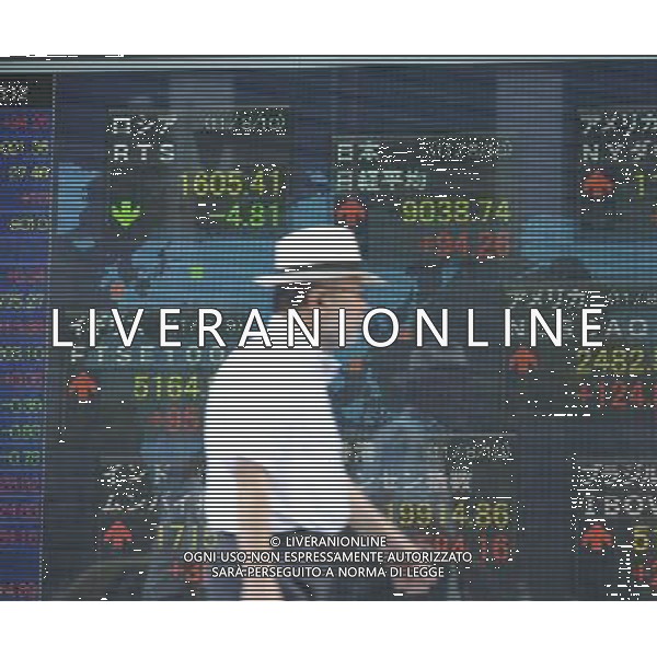 (110810) TOKYO, Aug.10, 2011 A man walks past a stock share price board in Tokyo, capital of Japan, Aug. 10, 2011. The benchmark 225 issue Nikkei Stock Average rose 94.26 points, or 1.05 percent, to close at 9,038.74 on Wednesday. (/Kenichiro Seki)(yt)