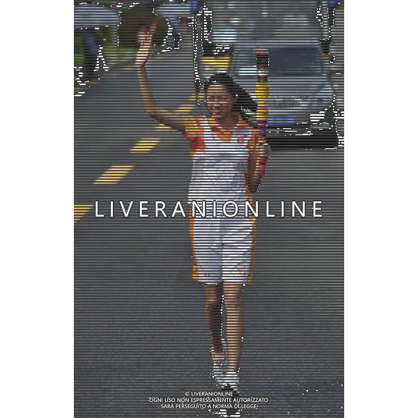 (110811) SHENZHEN, Aug. 11, 2011 () Torchbearer former Miss World Zhang Zilin relays the torch during the torch relay for the 6th Summer Universiade in Shenzhen, a city of south China\'s Guangdong Province, Aug. 11, 2011. (/Liang Xu)(wll)