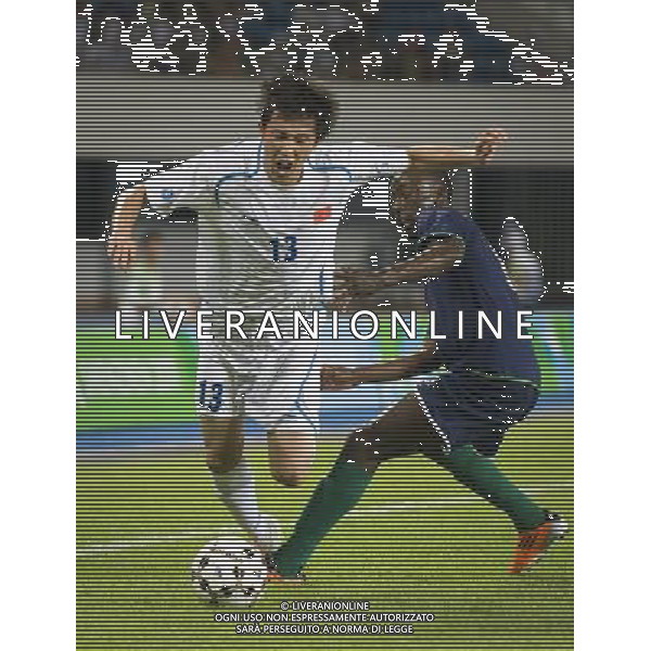 (110811) SHENZHEN, Aug. 11, 2011 Liu Lijia (L) of China vies with Simon Shikokola of Namibia during the group A preliminary match of men\'s football at the 26th Summer Universiade in Shenzhen, a city of south China\'s Guangdong Province, Aug. 11, 2011. The match ended with a 1 1 draw. (/Lui Siu Wai)(lm)