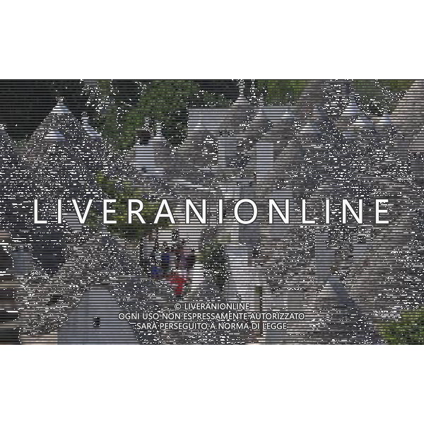 (110812) ALBEROBELLO, Aug. 12, 2011 Photo taken on Aug. 10, 2011 shows the Trulli in Alberobello, southern Italy. Alberobello, the city of drystone dwellings known as trulli, is an exceptional example of vernacular architecture. The trulli are made of roughly worked limestone boulders collected from neighbouring fields. Characteristically, they feature pyramidal, domed or conical roofs built up of corbelled limestone slabs. UNESCO inscribed the Trulli of Alberobello in the World Heritage List in 1996. (/Wang Qingqin)