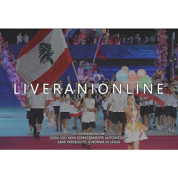 (110812)SHENZHEN, Aug. 12, 2011 Members of Lebanon\'s delegation enter the site during the opening ceremony of the 26th Summer Universiade in Shenzhen, a city of south China\'s Guangdong Province, on Aug. 12, 2011. (/Guo Yong)(kh)