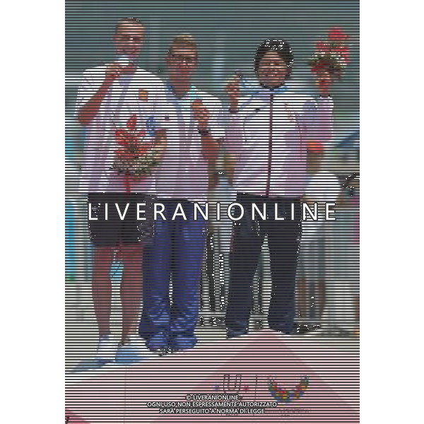(110813) -- SHENZHEN, Aug. 13, 2011 () -- Gold medalist Simone Ruffini (C) of Italy, silver medalist Kirill Abrosmov (L) of Russia and bronze medalist Hirai Yasunari of Japan react during the awarding ceremony for men\'s open water 10km swimming at the 26th Summer Universiade in Shenzhen, a city of south China\'s Guangdong Province, Aug. 13, 2011. Simone Ruffini claimed the title of the event with 1 hour 58 minutes 0.747 seconds to win the first gold medal of the 26th Summer Universiade. (/Lui Siu Wai)(kh)