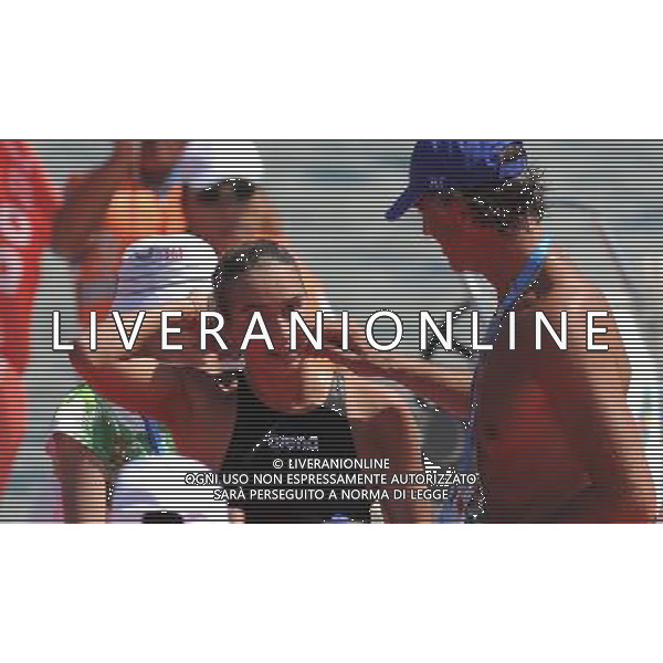 (110813) -- SHENZHEN, Aug. 13, 2011 () -- Rachele Bruni (L) of Italy receives congratulations from her coach after winning the women\'s open water 10km swimming at the 26th Summer Universiade in Shenzhen, a city of south China\'s Guangdong Province, Aug. 13, 2011. Rachele Bruni claimed the title of the event with 2 hours 6 minutes and 49.31 seconds. (/Lu Hanxin)(kh)