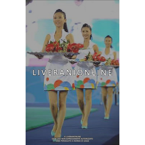 (110814) -- SHENZHEN, Aug. 14, 2011 () -- Medal presenters work during the awarding ceremony of a judo event at the 26th Summer Universiade in Shenzhen, a city of south China\'s Guangdong Province, Aug. 13, 2011. A total of 290 female volunteers and 60 male volunteers from China\'s colleges and universities serve as medal presenters at awarding ceremonies of 306 events of the 26th Summer Universiade. (/Liu Dawei) (wll)