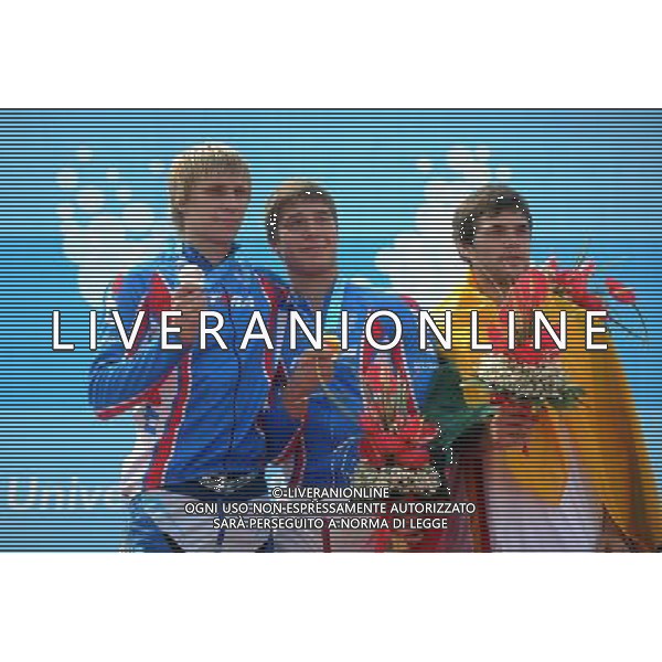 (110814) -- SHENZHEN, Aug. 14, 2011 () -- Gold medalist Kleshchenko Evgeniy (C) of Russia, his teammate silver medalist Yshkin Kirill (L) and bronze medalist Biknius Tautvydasreact of Lithuania pose at the awarding ceremony for the men\'s BMX individual race at the 26th Summer Universiade in Shenzhen, a city of south China\'s Guangdong Province, Aug. 14, 2011. Kleshchenko Evgeniy claimed the title of the event with 31.654 seconds. (/Li Ga) (bxf)