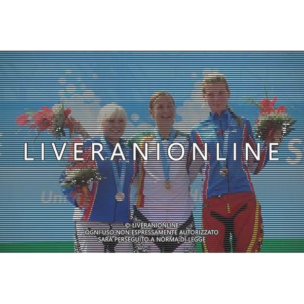 (110814) -- SHENZHEN, Aug. 14, 2011 () -- Gold medalist Rimsaite Vilma (R) of Lithuania, silver medalist Beskhmelnova Marina of Russia and her teammate bronze medalist Lomakova Margarita react during the aword ceremony for the women\'s BMX individual race at the 26th Summer Universiade in Shenzhen, a city of south China\'s Guangdong Province, Aug. 14, 2011. Rimsaite Vilma claimed the title of the event with 37.400 seconds. (/Li Ga) (bxf)