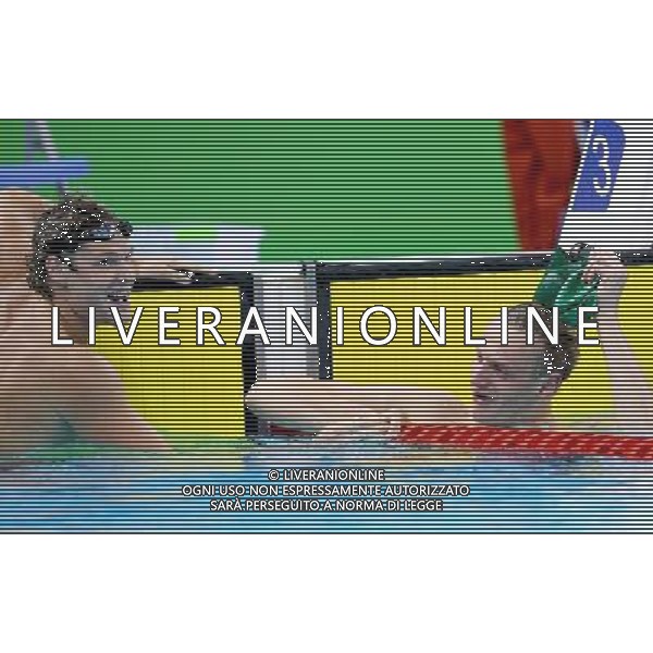 SHENZHEN, Aug. 14, 2011 Glenn Snyders (L) of New Zealand and Giedrius Titenis of Lithuania react after the final of the men\'s 200m breaststroke at the 26th Summer Universiade in Shenzhen, a city of south China\'s Guangdong Province, Aug. 14, 2011. Glenn Snyders and Giedrius Titenis won the gold with the same time of 2:10.85. (/Chen Jianli) (wll)