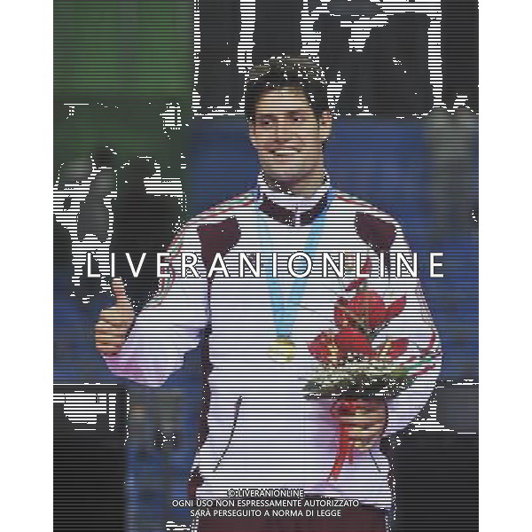 SHENZHEN, Aug. 14, 2011 Peter Szenyi (L) of Hungary thumbs up during the awarding ceremony of men\'s epee individual at the 26th Summer Universiade in Shenzhen, a city of south China\'s Guangdong Province, Aug. 14, 2011. Peter Szenyi took the gold medal of the event. (/Wang Haofei)