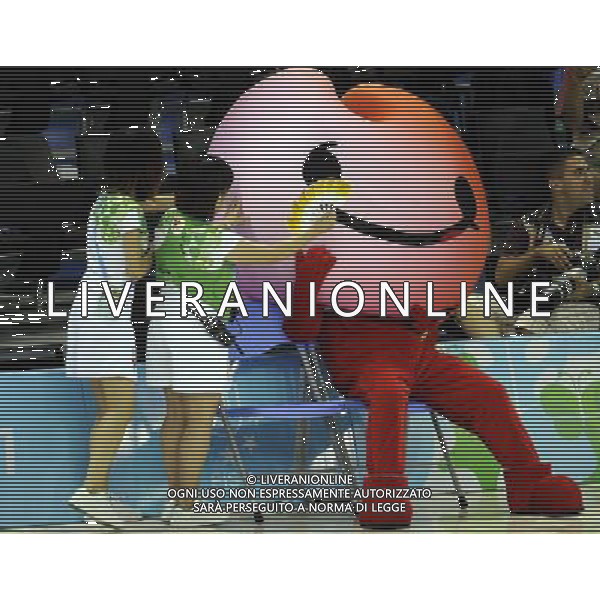 SHENZHEN, Aug. 14, 2011 Two volunteers waves a fan for the volunteer who dressed up as the mascot UU before the swimming events at the 26th Summer Universiade in Shenzhen, a city of south China\'s Guangdong Province, Aug. 14, 2011. (/Liang Xu) (wll)