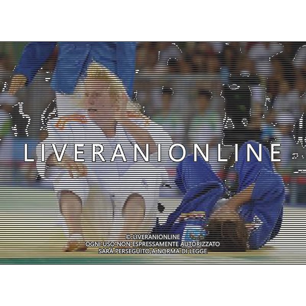 SHENZHEN, Aug. 14, 2011 Kim Polling (L) of the Netherlands reacts after winning the final of the women\'s 70kg of judo against Laura Vargas Koch of Germany in the 26th Summer Universiade at Conference and Exhibiton Center (Hall 8) in Shenzhen, a city of south China\'s Guangdong Province, Aug. 14, 2011. Kim Polling claimed the title of the event. (/Liu Dawei) (wll)