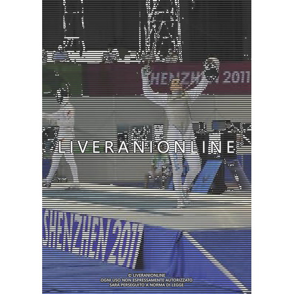 SHENZHEN, Aug. 15, 2011 Martino Minuto (R) of Italy celebrates after winning men\'s foil individual final against Lei Sheng of China at the 26th Summer Universiade in Shenzhen, a city of south China\'s Guangdong Province, Aug. 15, 2011. Martino Minuto won 15 13 to claim the title of the event. (/Wang Haofei)(kh)