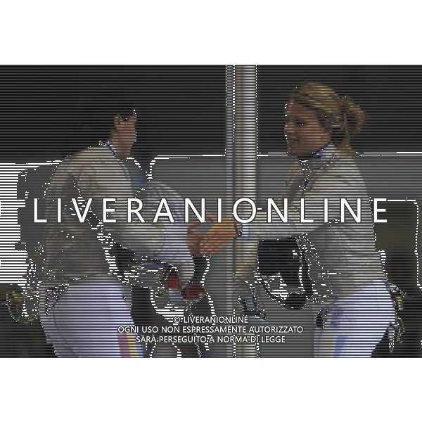 SHENZHEN, Aug. 15, 2011 Olga Kharlan of Ukraine (R) shakes hands with Alexandra Pascu of Romania after their women\'s sabre individual final at the 26th Summer Universiade in Shenzhen, a city of south China\'s Guangdong Province, Aug. 15, 2011. Kharlan won 15 9 to claim the title of the event. (/Guo Yong)(kh)