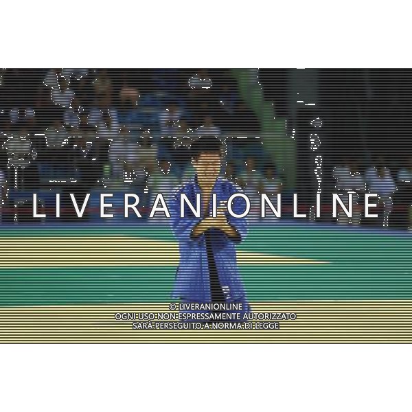 SHENZHEN, Aug. 15, 2011 Hwang Bo Bae of South Korea (blue) celebrates winning over Yuito Yoshida of Japan during their men\'s Judo 66KG final match at the 26th Summer Universiade in Shenzhen, a city of south China\'s Guangdong Province, Aug. 15, 2011. Hwang Bo Bae defeated Yuito Yoshida and claimed the gold medal of the event. (/Liu Dawei)