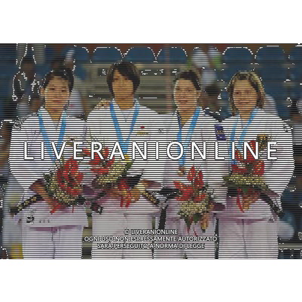 SHENZHEN, Aug. 15, 2011 Gold medalist Ishikawa Megumi (2nd L) of Japan, silver medalist Kim Jan Di (1st L) of South Korea, bronze medalists Helene Receveaux (2nd R) of France and Hannah Luise Brueck of Germany pose for group pictures during the awarding ceremony of women\'s Judo 57KG at the 26th Summer Universiade in Shenzhen, a city of south China\'s Guangdong Province, Aug. 15, 2011. (/Liu Dawei)