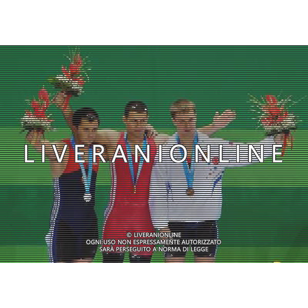 (110815) -- SHENZHEN, Aug. 15, 2011 () -- Gold medalist Aghasyan Aghasi (C) of Armenia, silver medalist Lastukhin Viacheslav (L) of Russia, and bronze medalist Kharchenko Victor of Russia react during the awarding ceremony for men\'s 77kg weightlifting at the 26th Summer Universiade in Shenzhen, a city of south China\'s Guangdong Province, Aug. 15, 2011. (/Wang Song) (kh)