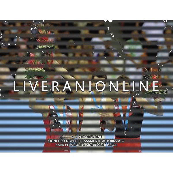 (110815) -- SHENZHEN, Aug. 15, 2011 () -- Gold medalist Mykola Kuksenkov (C) of Ukraine, silver medalist Yamamoto Shoichi (L) of Japan and Nathan Gafuik pose for group pictures during the awarding ceremony for men\'s individual all-round of artistic gymnastics at the 26th Summer Universiade in Shenzhen, a city of south China\'s Guangdong Province, Aug. 15, 2011. (/Lin Yiguang)(kh)