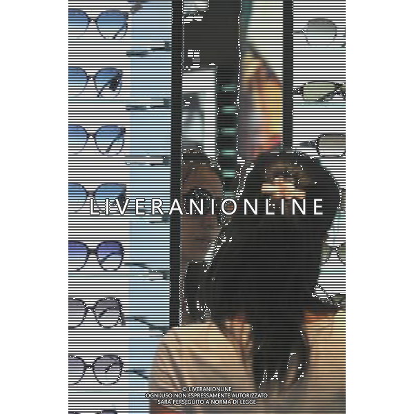 (110814) -- SANYA, Aug. 14, 2011 () -- A girl tries glasses at a tax-free shop in Sanya, south China\'s Hainan Province, Aug. 12, 2011. The offshore tax-free scheme kicked off on a trial basis across Hainan from April 20, and was formally launched on May 1. Up to Aug. 10, the tax-free shop in Sanya has received over 1.3 million customers and more than 340,000 deals have been made. (/Hou Jiansen) (lj)(hdt)