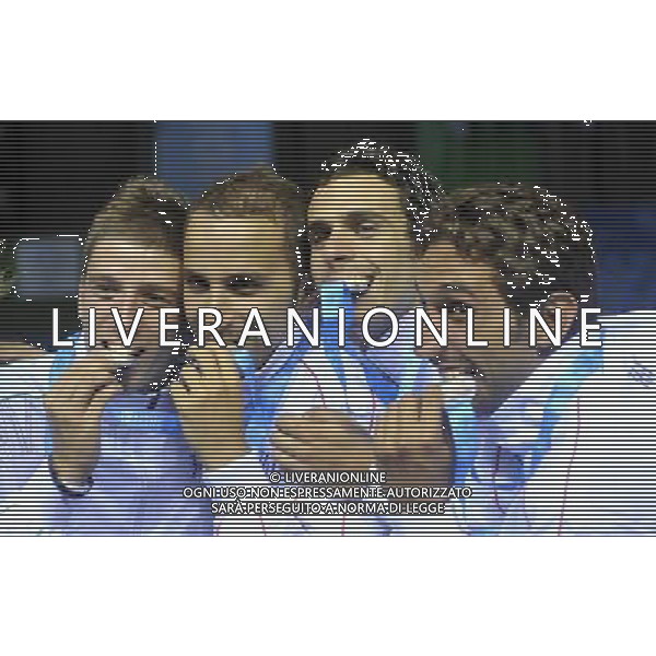 (110816) -- SHENZHEN, Aug. 16, 2011 () -- Players of Italy bite their silver medals during the awarding ceremony for the men\'s sabre team match of fencing event at the 26th Summer Universiade, in Shenzhen, a city of south China\'s Guangdong Province, Aug. 16, 2011. Ukraine defeated Italy 45-31 and got the gold medal. (/Wang Haofei)(bxf)