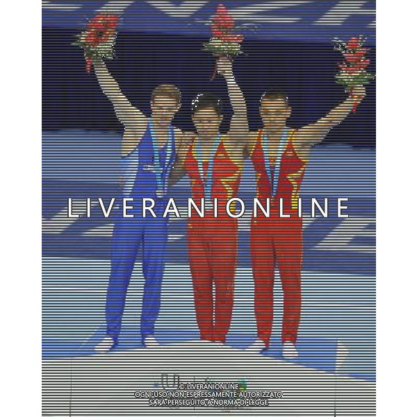 (110816) -- SHENZHEN, Aug. 16, 2011 () -- Gold medalist Wang Guanyin of China (R), silver medalist Liu Rongbing (C) of China and Marius Berbecar of Romania celebrate during the awarding ceremony for the men\'s parallel bars of artistic gymnastics event at the 26th Summer Universiade, in Shenzhen, a city of south China\'s Guangdong Province, Aug. 16, 2011. (/Gong Lei)(bxf)