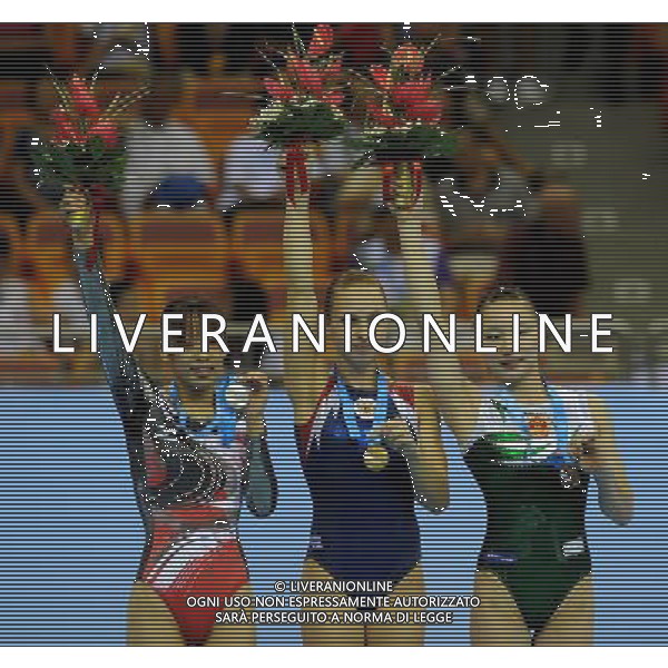(110816) -- SHENZHEN, Aug. 16, 2011 () -- Gold medalist Alena Polyan of Russia (C), silver medalist Mukumoto Keiko of Japan (L) and bronze medalist Xiao Kangjun of China celebrate during the awarding ceremony for the women\'s floor exercise of artistic gymnastics event at the 26th Summer Universiade, in Shenzhen, a city of south China\'s Guangdong Province, Aug. 16, 2011. (/Lin Yiguang)(bxf)