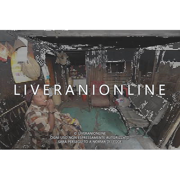 JOHANNESBURG, Aug. 16, 2011 Reginal enjoys snack at home in a slum in Samampelo, Johannesburg, South Africa, Aug. 14, 2011. Over 15,000 people live in this slum, most of whom live on hard labour or small business. (/Li Qihua) (msq)