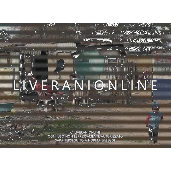 JOHANNESBURG, Aug. 16, 2011 Residents chat at a slum in Samampelo, Johannesburg, South Africa, Aug. 14, 2011. Over 15,000 people live in this slum, most of whom live on hard labour or small business. (/Li Qihua) (msq)