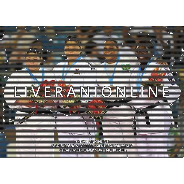 SHENZHEN, Aug. 16, 2011 Gold medalist Kim Ji Youn of South Korea (2nd L), silver medalist Aya Ishiyama of Japan (1st L) and bronze medalists Claudirene Cezar of Brazil (2nd R) and Emilie Andeol of France pose for group photos during the awarding ceremony of women\'s open Judo competition at the 26th Summer Universiade in Shenzhen, a city of south China\'s Guangdong Province, Aug. 16, 2011. (/Liu Dawei)