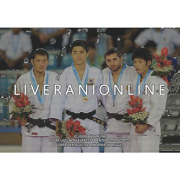 SHENZHEN, Aug. 16, 2011 Gold medalist Kim Won Jin of South Korea (2nd L), silver medalist Otgon Chinbat of Mongolia (1st L) and bronze medalists Robert Mshvidobadze of Russia (2nd R) and Toru Shishime of Japan pose for group photos during the awarding ceremony of men\'s 60kg Judo competition at the 26th Summer Universiade in Shenzhen, a city of south China\'s Guangdong Province, Aug. 16, 2011. (/Liu Dawei)