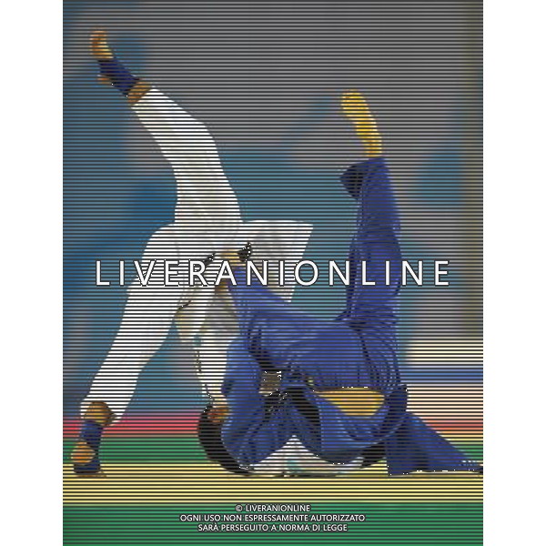 SHENZHEN, Aug. 16, 2011 Kim Won Jin of South Korea (blue) competes with Otgon Chinbat of Mongolia during their men\'s Judo 60KG final match at the 26th Summer Universiade in Shenzhen, a city of south China\'s Guangdong Province, Aug. 16, 2011. Kim Won Jin won the match and claimed the gold medal of the event. (/Liu Dawei)