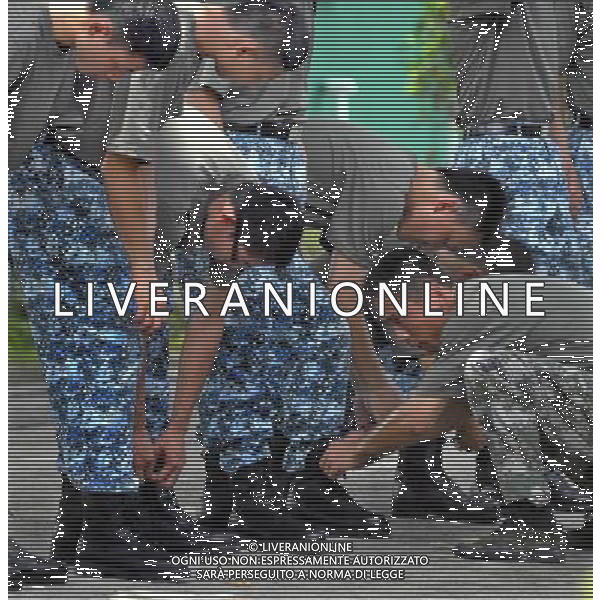 (110817) -- HONG KONG, Aug. 17, 2011 () -- An officer teaches student trainees how to wear combat boots properly during a summer military camp in Hong Kong, south China, Aug. 15, 2011. A total of 100 students from Hong Kong-based colleges and universities finished a ten-day summer military camp here Wednesday. (/Ma Zheng) (ljh)