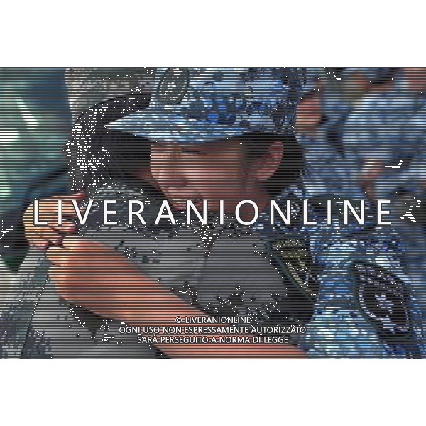 (110817) -- HONG KONG, Aug. 17, 2011 () -- A student trainee gives an officer a emotional farewell hug as she leaves a barrack of the People\'s Liberation Army (PLA) Hong Kong Garrison in Hong Kong, south China, Aug. 17, 2011. A total of 100 students from Hong Kong-based colleges and universities finished a ten-day summer military camp here Wednesday. (/Chen Xiaowei) (ljh)