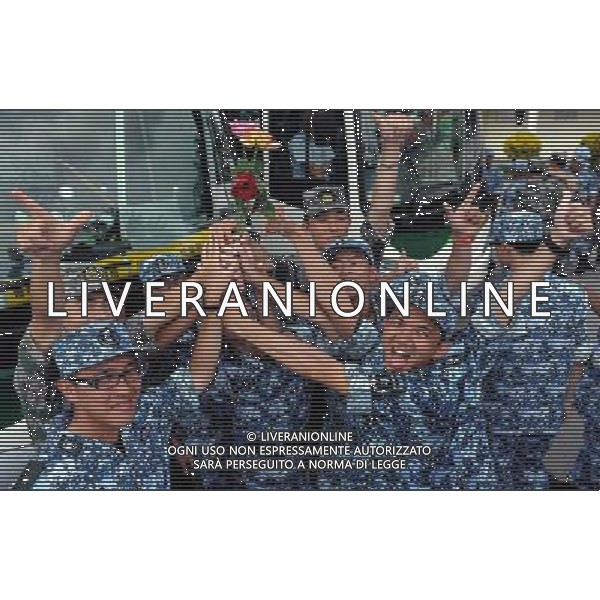 (110817) -- HONG KONG, Aug. 17, 2011 () -- Student trainees celebrate with their commanding officers as they leave a barrack of the People\'s Liberation Army (PLA) Hong Kong Garrison in Hong Kong, south China, Aug. 17, 2011. A total of 100 students from Hong Kong-based colleges and universities finished a ten-day summer military camp here Wednesday. (/Chen Xiaowei) (ljh)