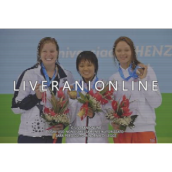 (110817) -- SHENZHEN, Aug. 17, 2011 () -- Gold medalist Sakai Shiho of Japan (C), silver medalist Jennifer Connolly of the United States (L), and bronze medalist Aliaksandra Herasimenia of Belarussia celebrate at the awarding ceremony of the women\'s 100m backstroke of swimming at the 26th Summer Universiade in Shenzhen, a city of south China\'s Guangdong Province, Aug. 17, 2011. (/Liang Xu)