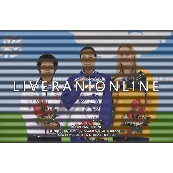 (110817) -- SHENZHEN, Aug. 17, 2011 () -- Gold medalist Lu Ying of China (C), silver medalist Tomoyo Fukuda of Japan (L), and bronze medalist Alice Mills of Australia celebrate at the awarding ceremony of the women\'s 100m butterfly of swimming at the 26th Summer Universiade in Shenzhen, a city of south China\'s Guangdong Province, Aug. 17, 2011. (/Liang Xu)