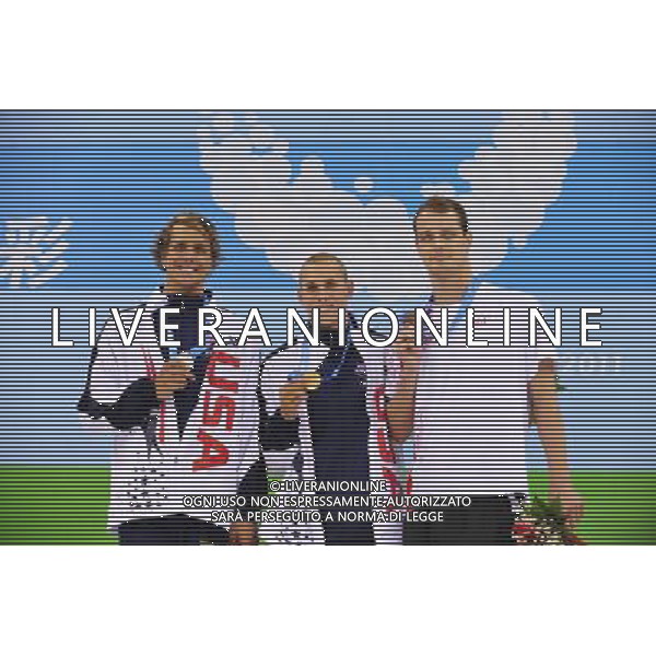 (110816) -- SHENZHEN, Aug. 16, 2011 () -- Gold medalist Timothy Phillips of the United States (C), silver medalist Thomas Shields of the United States (L), and bronze medalist Pawel Korzeniowski of Poland pose at the awarding ceremony of the men\'s 100m butterfly of swimming at the 26th Summer Universiade in Shenzhen, a city of south China\'s Guangdong Province, Aug. 16, 2011. (/Liang Xu)